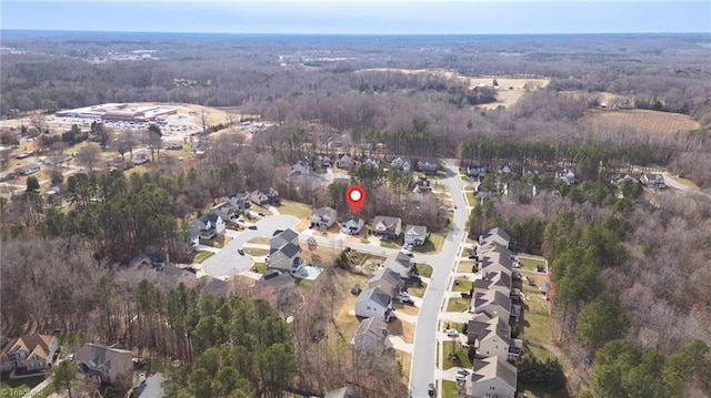 birds eye view of property with a forest view and a residential view