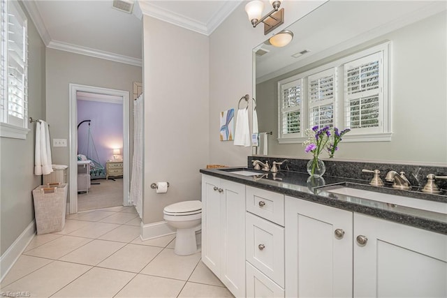 ensuite bathroom with tile patterned flooring, crown molding, visible vents, and a sink