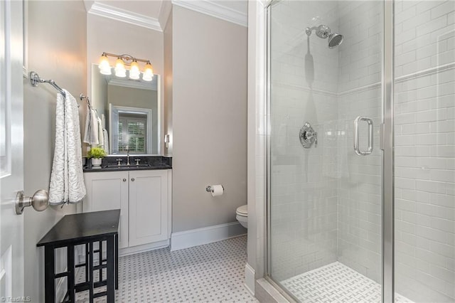 bathroom featuring vanity, crown molding, baseboards, and a stall shower