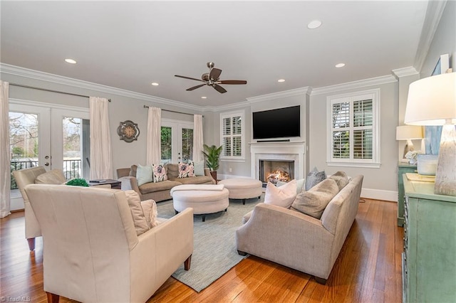 living area featuring light wood-style flooring, plenty of natural light, and french doors