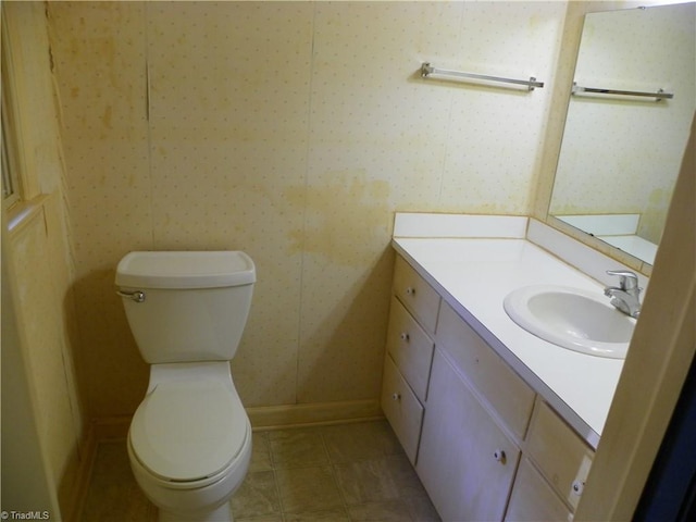 bathroom featuring vanity, toilet, and tile patterned flooring