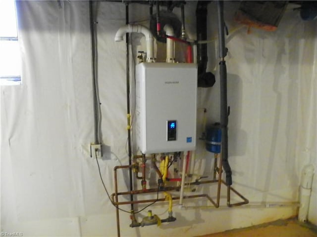 utility room featuring water heater