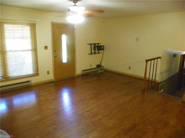 entryway with a baseboard heating unit, dark hardwood / wood-style floors, and ceiling fan