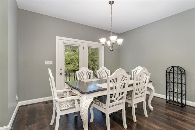 817 Jefferson Rd, Greensboro, NC 27410 - dining area with a chandelier, dark wood-type flooring, and baseboards