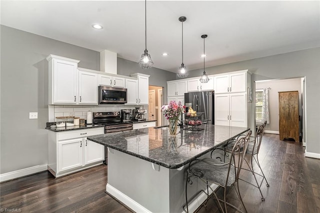 817 Jefferson Rd, Greensboro, NC 27410 - kitchen with stainless steel appliances, white cabinets, recessed lighting, dark wood finished floors, and baseboards