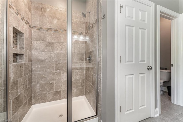817 Jefferson Rd, Greensboro, NC 27410 - full bath featuring a shower stall, toilet, and tile patterned flooring
