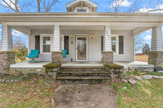 view of exterior entry featuring a porch