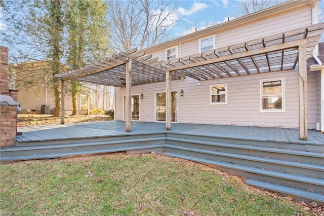 rear view of property with a yard, a pergola, and a deck