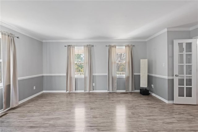 empty room with light wood-type flooring and ornamental molding