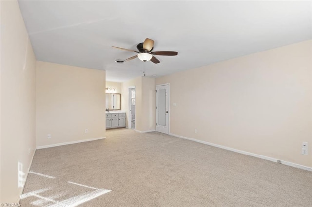 spare room with light carpet and ceiling fan