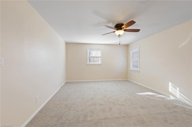 carpeted spare room with ceiling fan