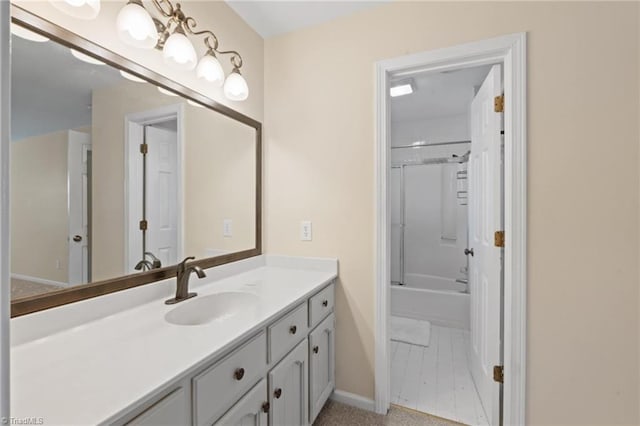 bathroom with vanity and combined bath / shower with glass door