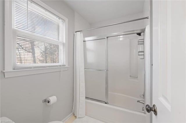 bathroom with toilet and shower / tub combo