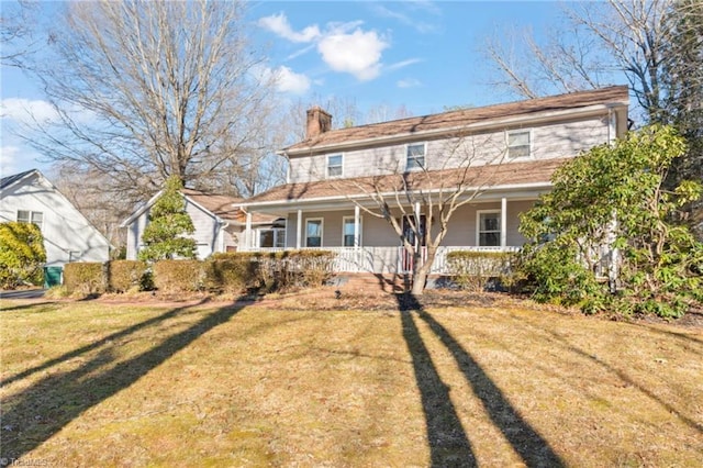 view of front of property with covered porch and a front lawn