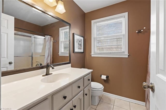 bathroom featuring toilet, vanity, tile patterned floors, and a shower with shower curtain