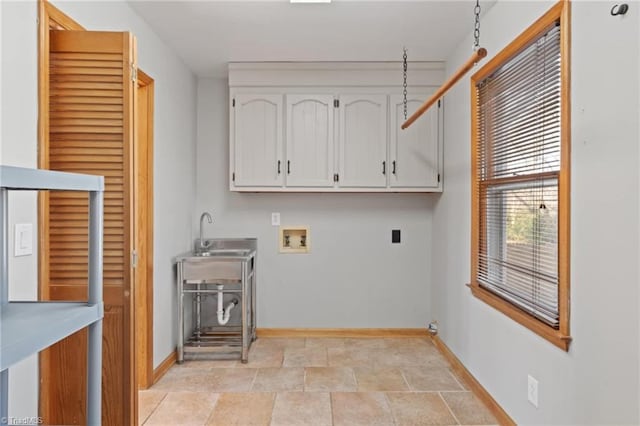 clothes washing area with electric dryer hookup, sink, cabinets, and washer hookup