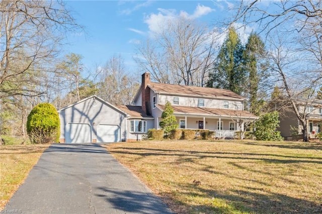 view of front facade featuring a front yard, a porch, and a garage