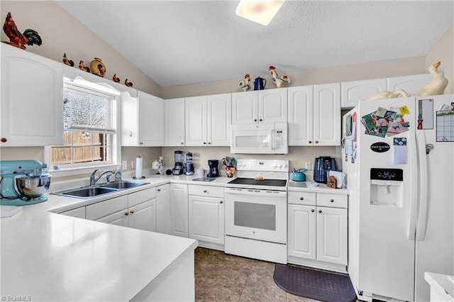 kitchen with a sink, white appliances, white cabinets, and light countertops