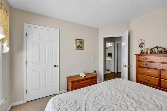 bedroom featuring carpet flooring, a textured ceiling, and baseboards