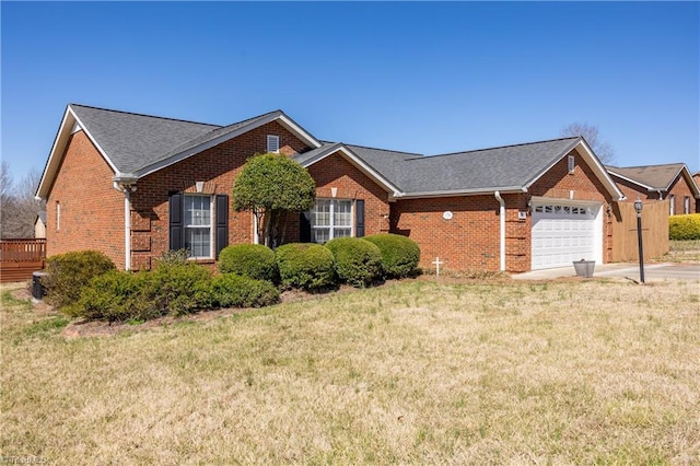 view of front of property with a front lawn, brick siding, concrete driveway, and an attached garage