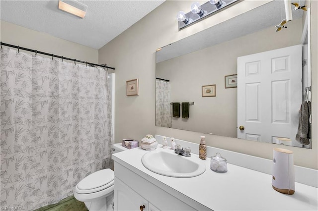 bathroom featuring vanity, curtained shower, toilet, and a textured ceiling