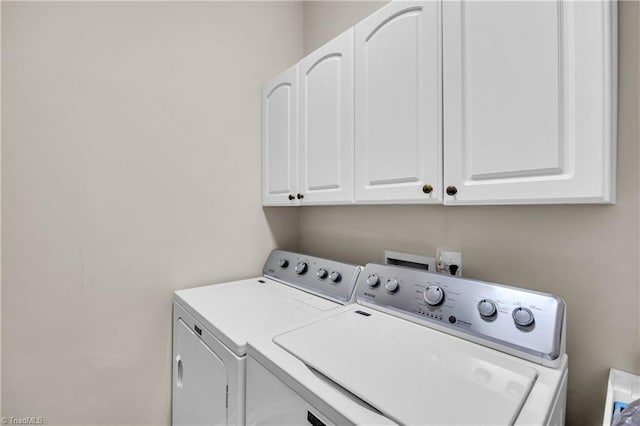 laundry area featuring cabinet space and separate washer and dryer