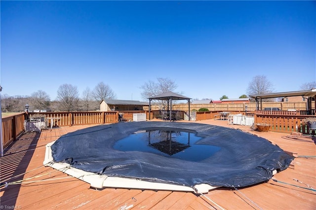 view of swimming pool with a deck and a gazebo