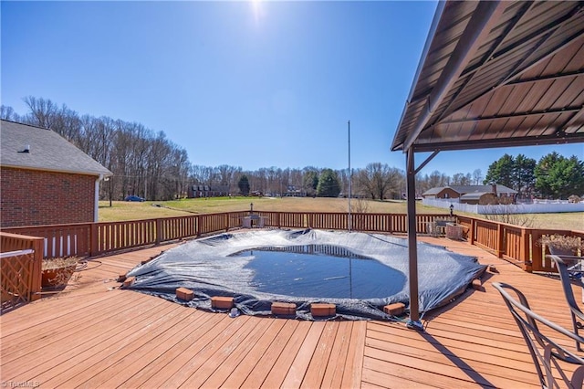 wooden terrace with a lawn