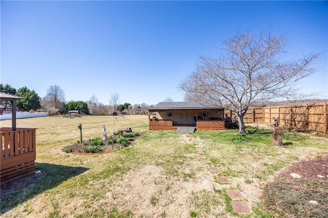 view of yard with a wooden deck and fence