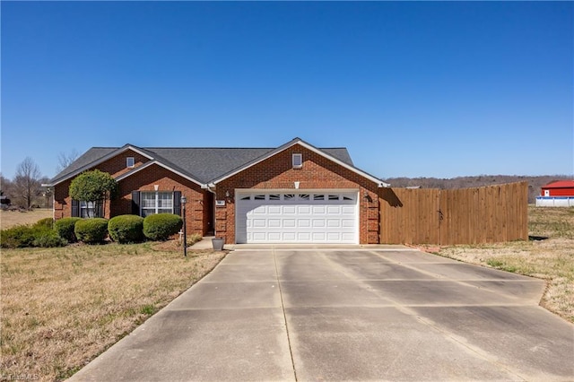 view of front facade featuring brick siding, concrete driveway, fence, and a garage