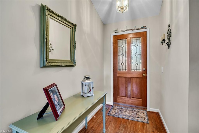 entrance foyer featuring baseboards and wood finished floors