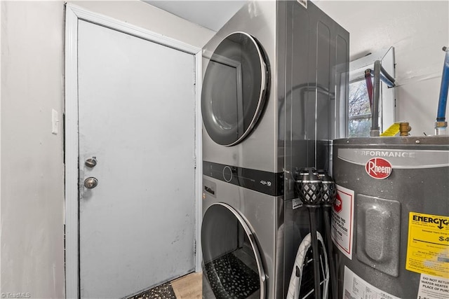 laundry room featuring stacked washer / dryer and electric water heater