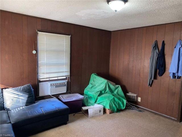 living area featuring cooling unit, wooden walls, light carpet, and a textured ceiling