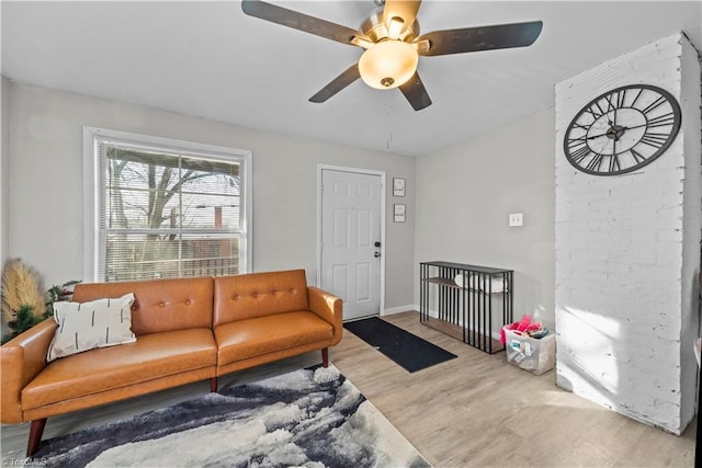 living room featuring ceiling fan and light hardwood / wood-style floors