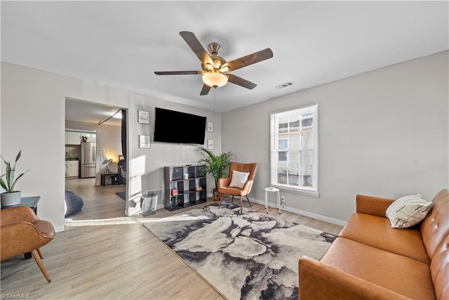 living room featuring hardwood / wood-style flooring and ceiling fan