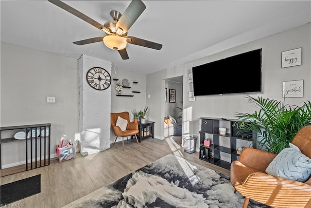 living room with light hardwood / wood-style floors and ceiling fan