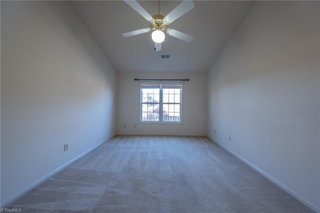 carpeted empty room featuring ceiling fan and lofted ceiling