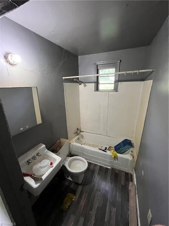 full bath featuring wood finished floors, toilet, and shower / bathtub combination