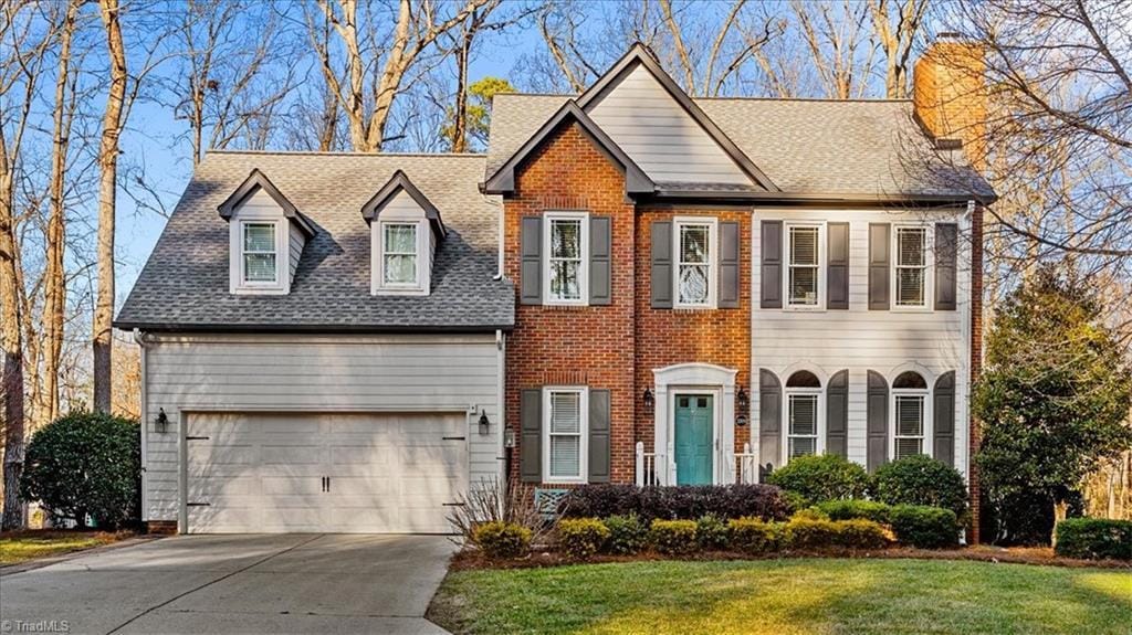 view of front of house with a garage and a front lawn