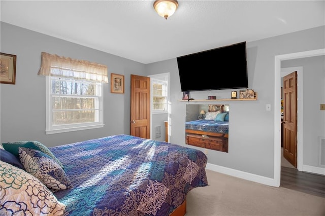 carpeted bedroom with multiple windows