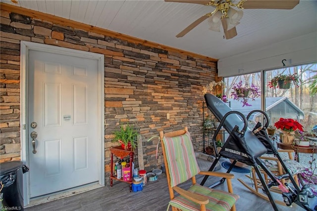 workout room featuring hardwood / wood-style flooring and ceiling fan