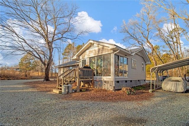 view of side of home featuring a carport and a sunroom