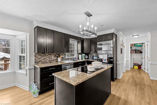 kitchen with light wood-type flooring, light stone counters, decorative backsplash, black electric stovetop, and dishwasher