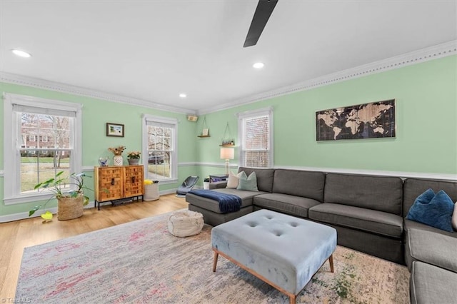 living area with ornamental molding, wood finished floors, recessed lighting, and ceiling fan