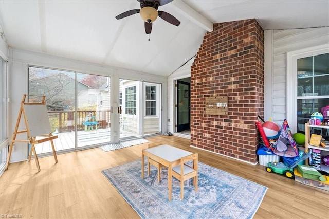 sunroom featuring lofted ceiling with beams and a ceiling fan