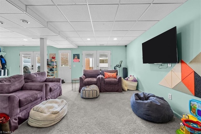 living room featuring baseboards, a drop ceiling, carpet floors, recessed lighting, and french doors