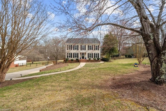 colonial inspired home with a front yard