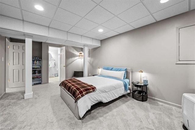 carpeted bedroom featuring recessed lighting, a paneled ceiling, baseboards, and connected bathroom