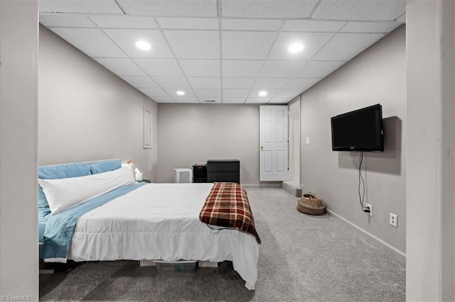 carpeted bedroom featuring a drop ceiling, recessed lighting, and baseboards