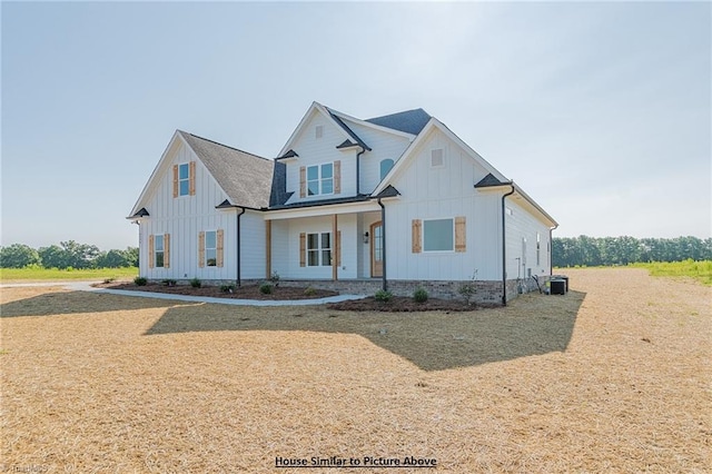 modern farmhouse featuring central air condition unit and a front yard